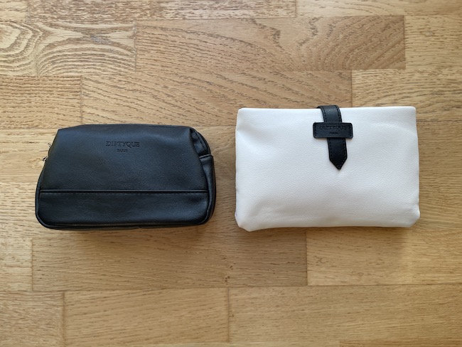 a black and white pouches on a wood surface