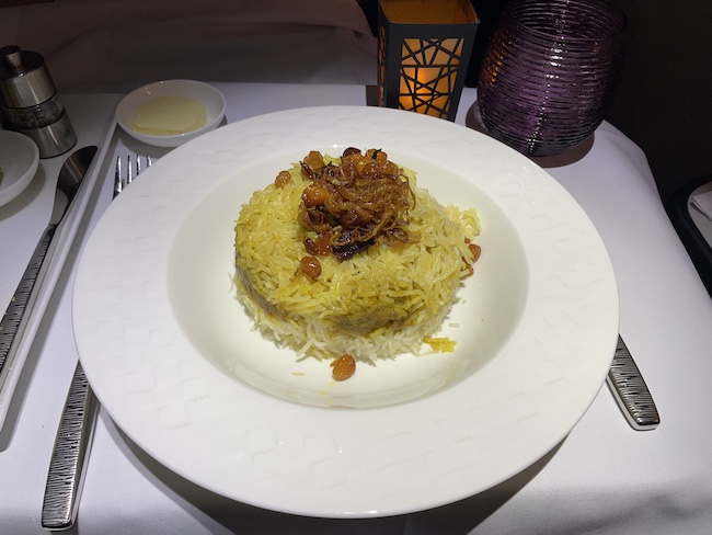 a plate of rice with raisins and raisins