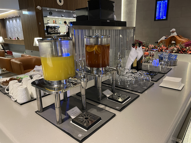 a drink dispenser with two cups of liquid