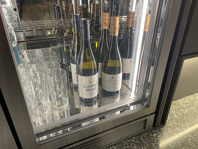 a group of bottles and glasses in a cooler