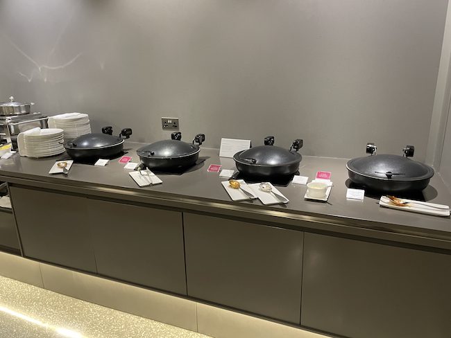 a row of black pans on a counter