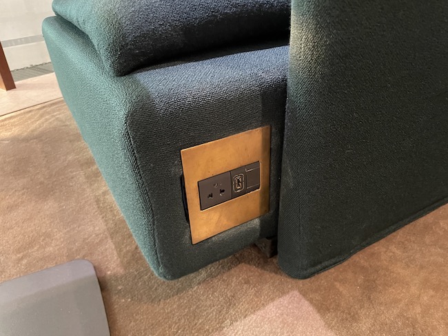 a rectangle with a gold plate on the corner of a couch