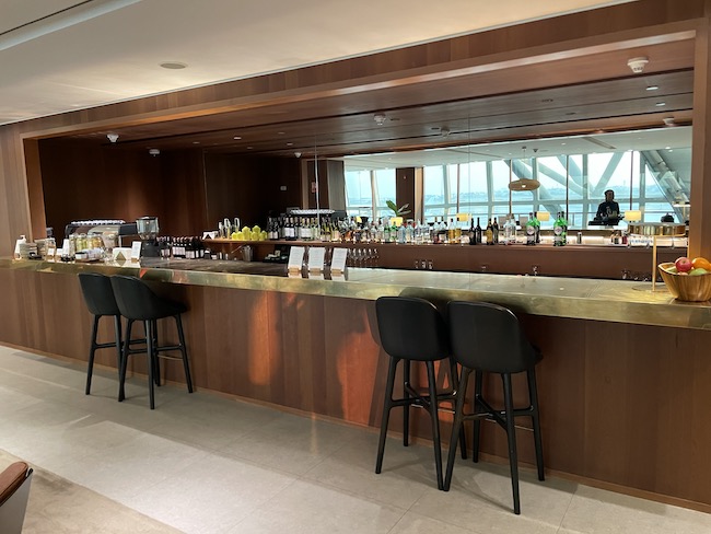 a bar with a counter and chairs