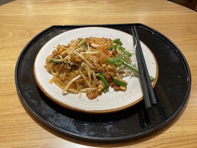 a plate of food with chopsticks on it