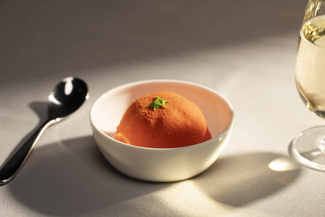 a bowl of orange ice cream