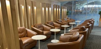 a group of brown chairs and tables in a room