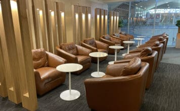 a group of brown chairs and tables in a room