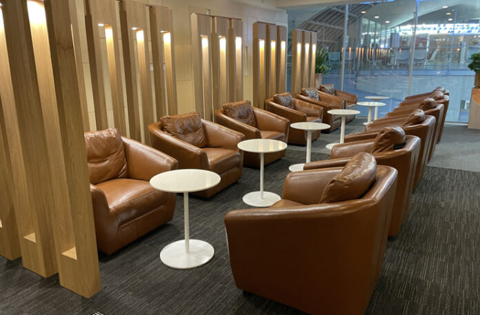 a group of brown chairs and tables in a room