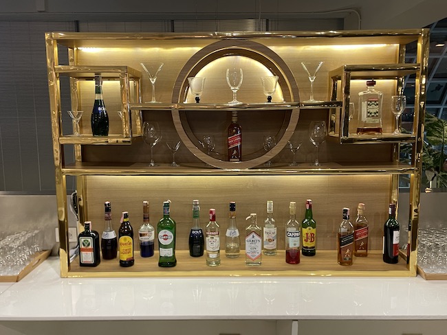 a shelf with bottles and glasses on it