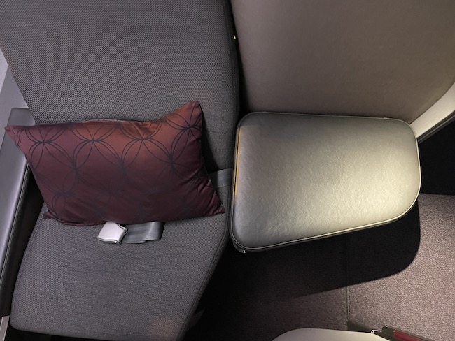 a pillow next to a seat