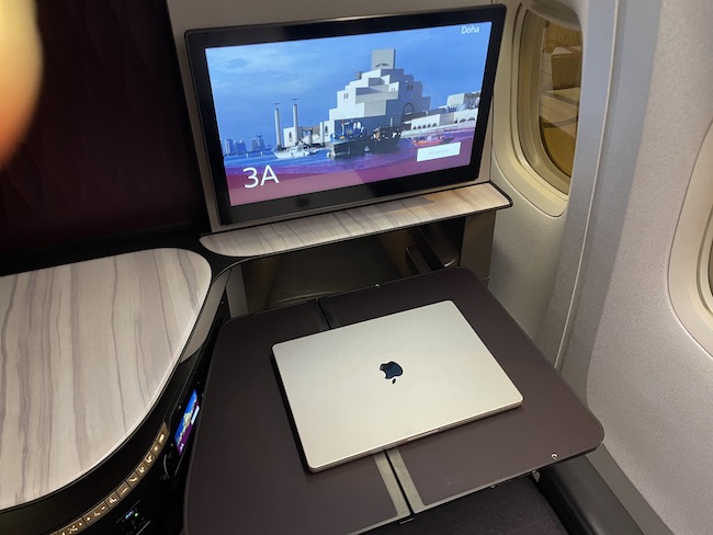 a laptop on a table in an airplane