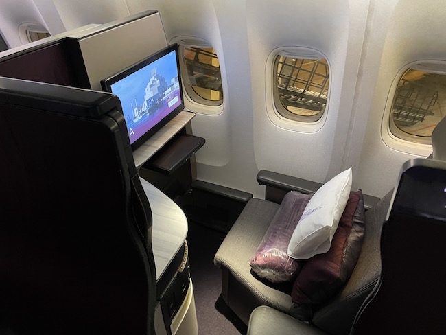a seat and a television in a plane