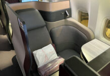 a seat with a white pillow on it