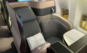 a seat with a white pillow on it