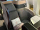a seat with a white pillow on it
