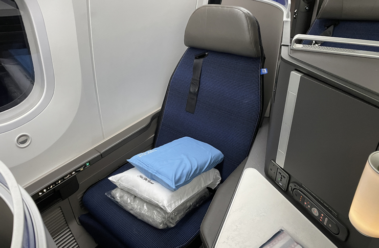 a seat with pillows and a pillow on it
