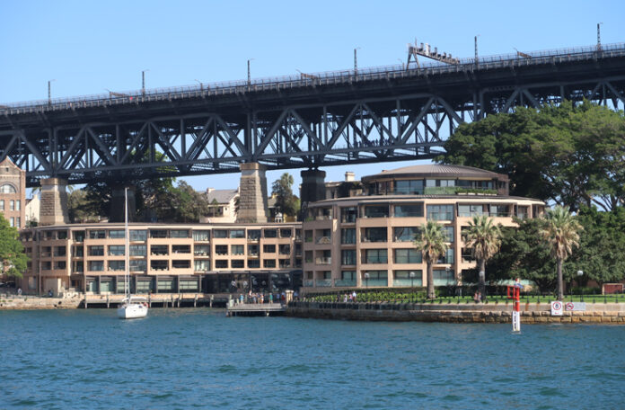 a bridge over water with buildings and trees