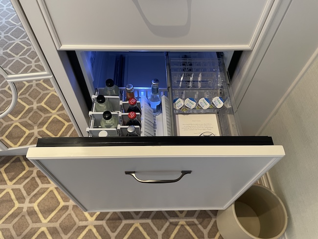 a drawer with a drink and bottles inside