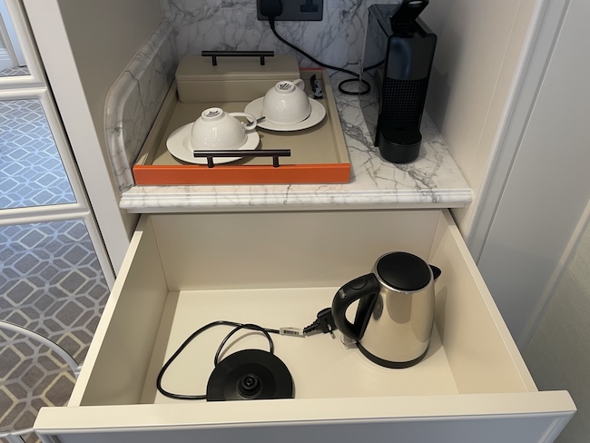 a teapot and cups in a drawer