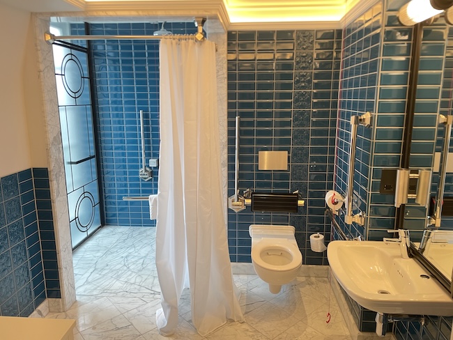 a bathroom with a shower curtain and sink