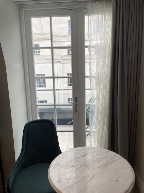 a table and chair in front of a window