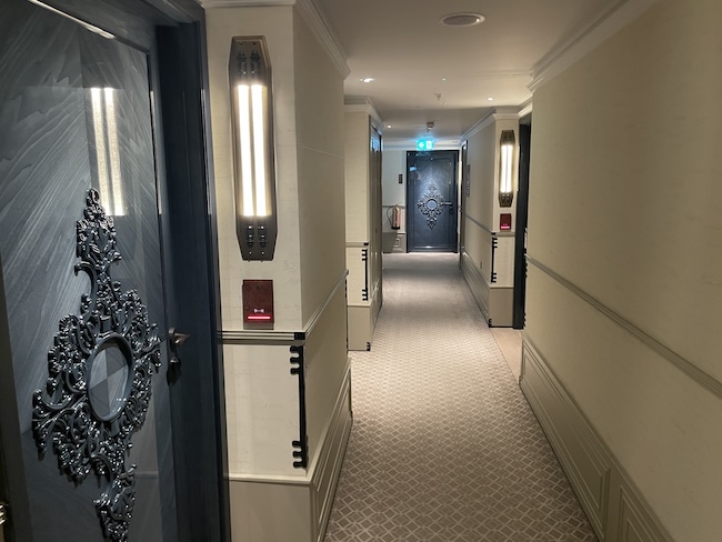 a hallway with a door and a black door