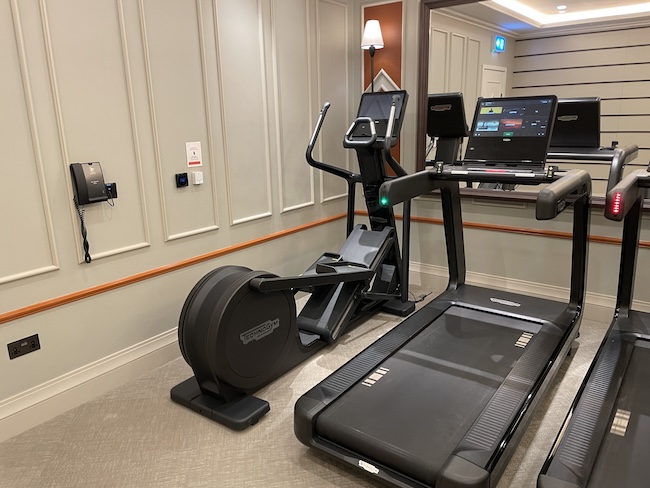 a treadmill and computer in a room