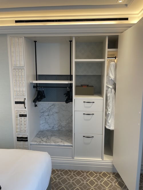 a closet with white shelves and white walls