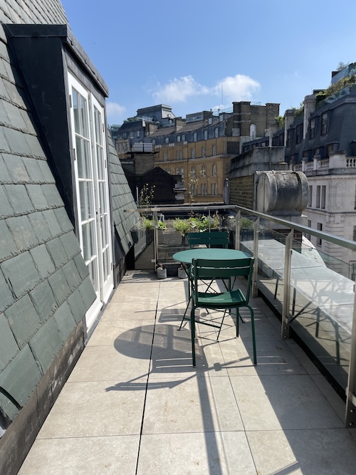 a table and chairs on a rooftop