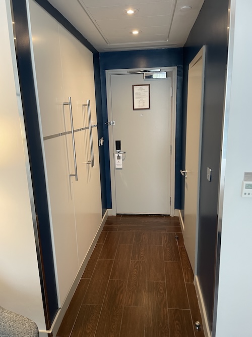 a hallway with white doors and a wood floor