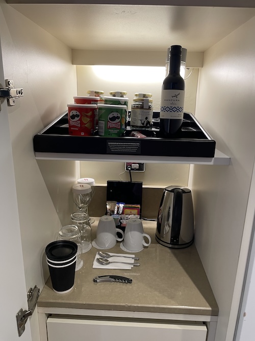 a shelf with food and coffee cups on it