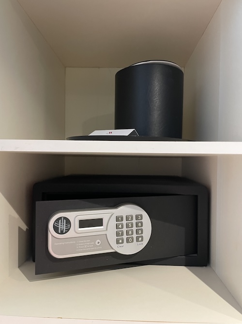 a black safe on a white shelf