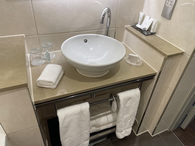 a sink with a faucet and towels on a counter