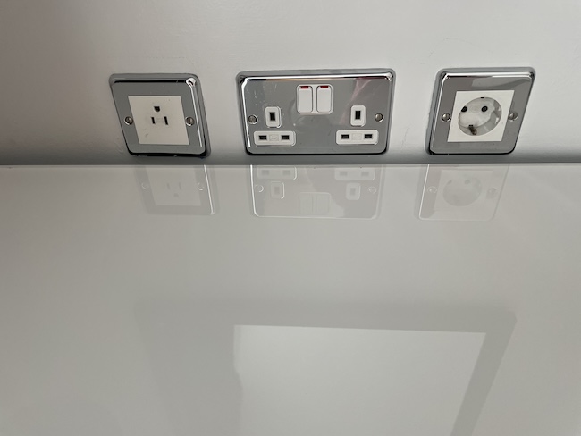 a row of electrical outlets on a white surface