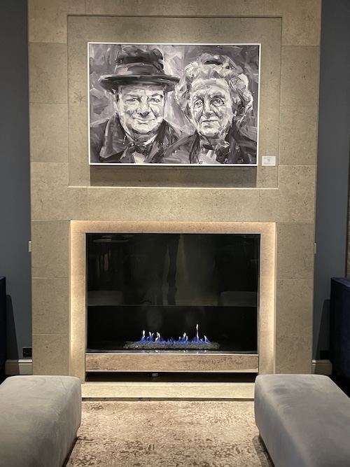 a painting on a wall above a fireplace