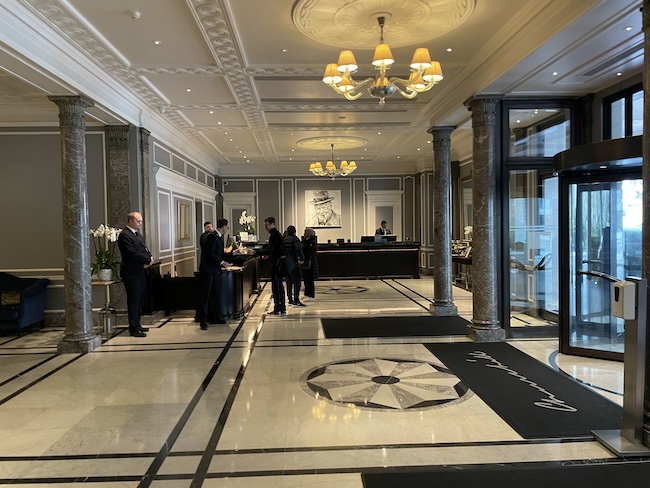 a group of people standing in front of a reception desk