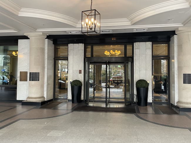 a building with glass doors and a chandelier