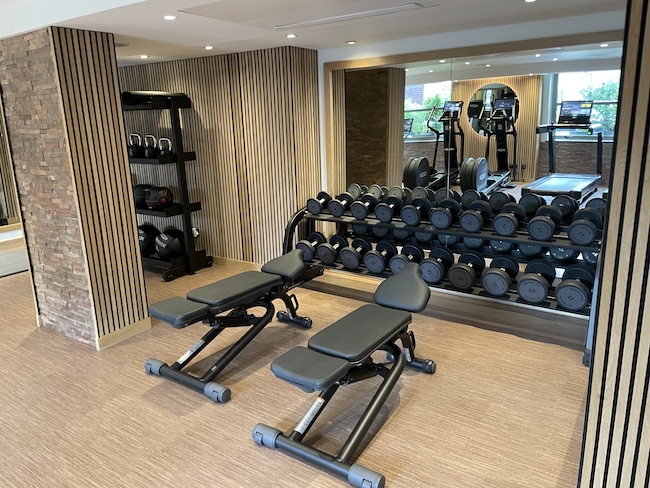 a gym with weights and a mirror