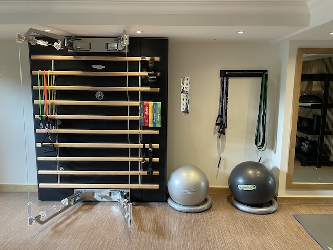 a gym with exercise balls and a wall bar