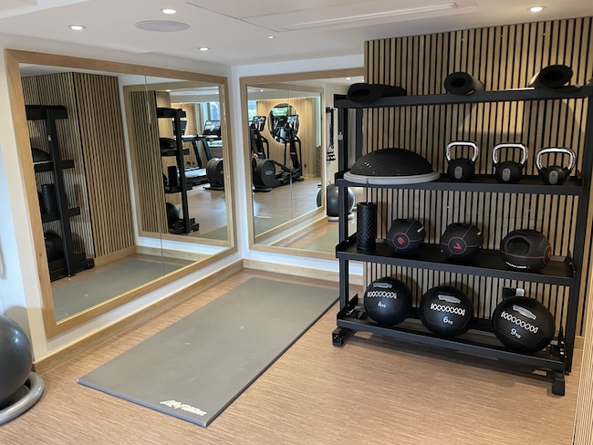 a room with a gym and exercise equipment