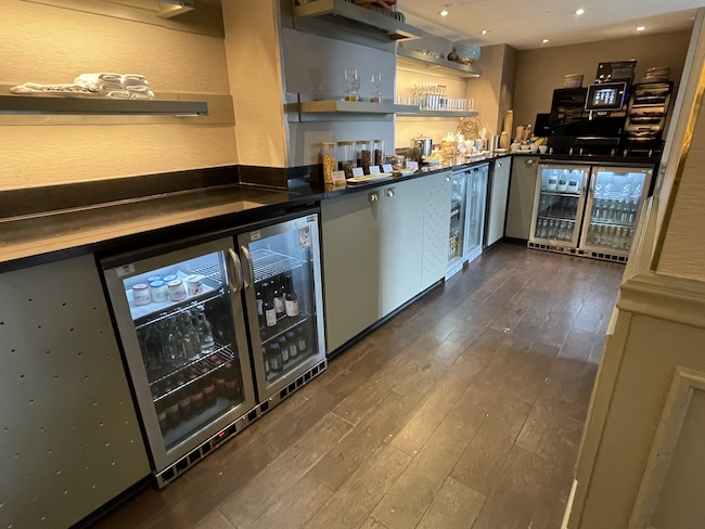 a room with a fridge and shelves