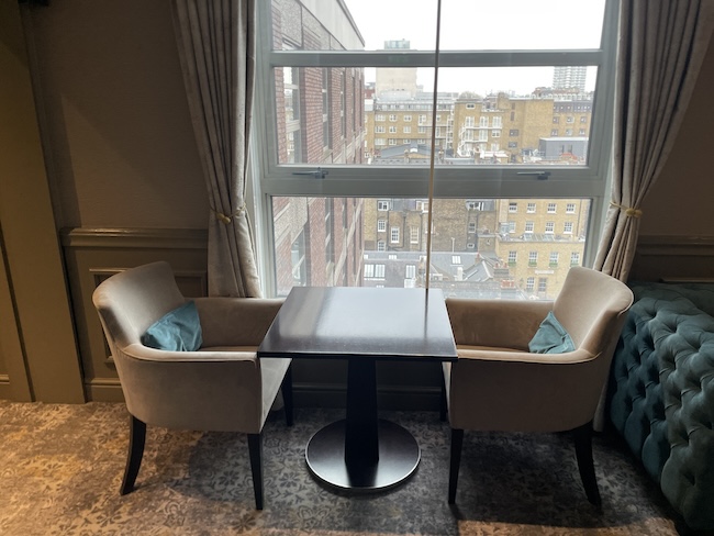 a table and chairs in a room with a window