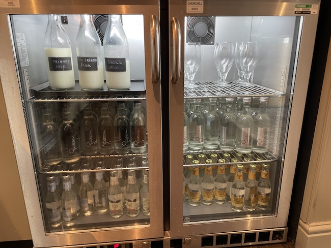 a refrigerator with bottles and glasses