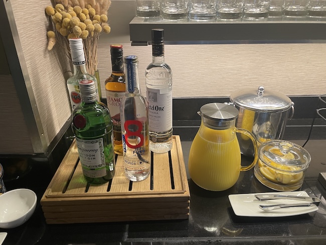 a group of bottles of alcohol on a wooden tray