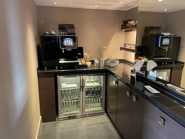 a kitchen with a refrigerator and a coffee machine