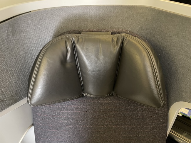 a black leather pillow on a chair