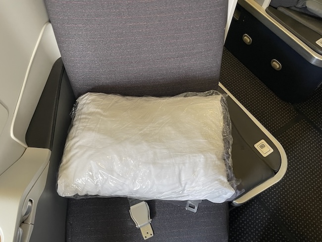 a pillow in a plastic bag on a seat