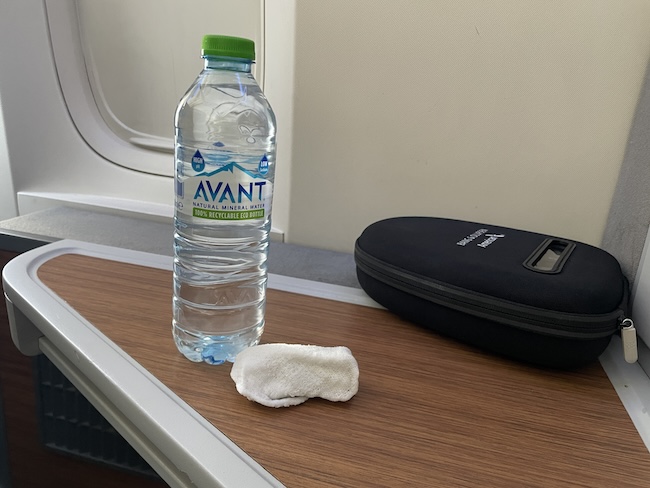 a bottle of water and a sponge on a table