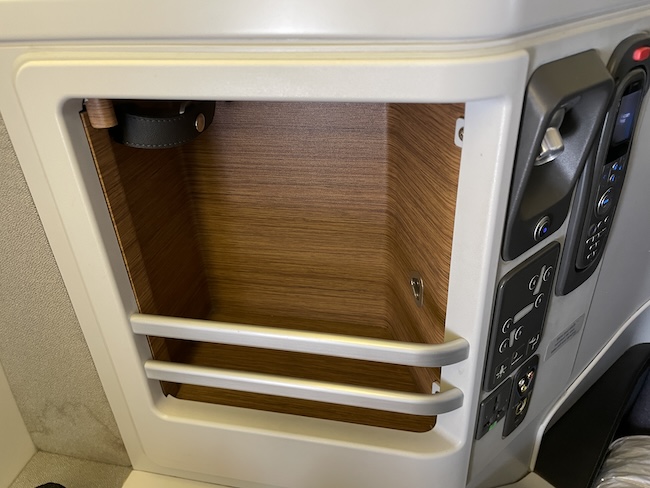 a small white object with a wooden shelf