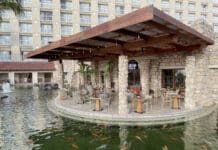 a restaurant with a pond and fish in the water